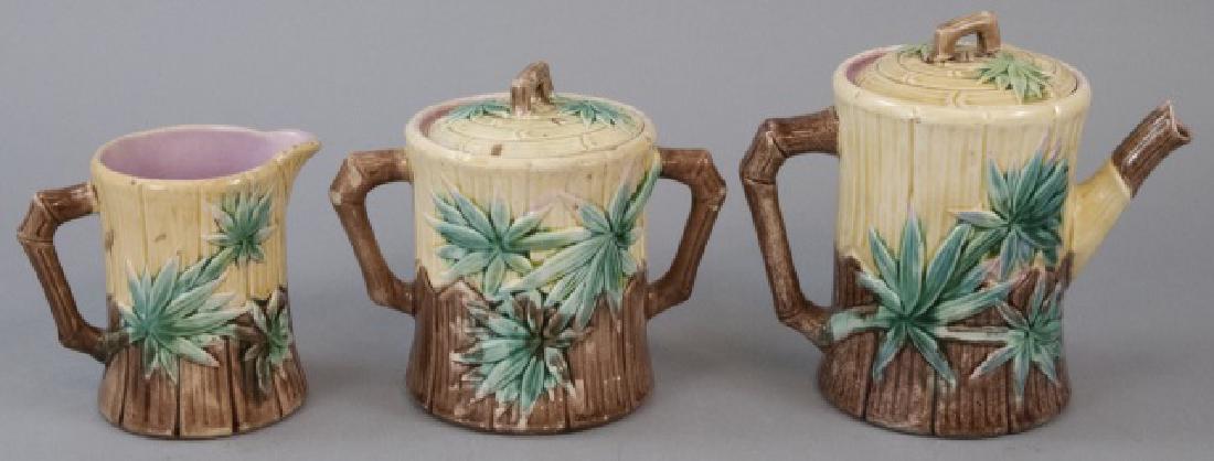 Matching E.Truscan Majolica Teapot Set: Antique or Vintage Matching Majolica Teapot, Creamer & Sugar Dish, this lot features a matching set of teacup, creamer, and sugar dish, the lot features yellow and brown color with green floral design