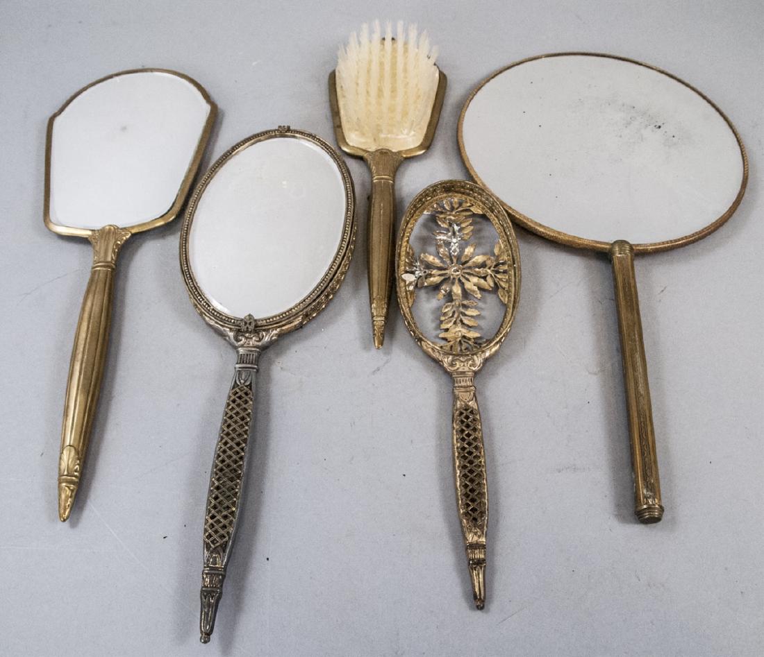 Lot Of Antique Bronze Hand Mirrors & Brush: Lot Of Antique Bronze Hand Mirrors & Brush, this lot features 4 different sized hand mirrors, one features a picture of a doll on the back side, the others are basic with ornate designs, the largest i