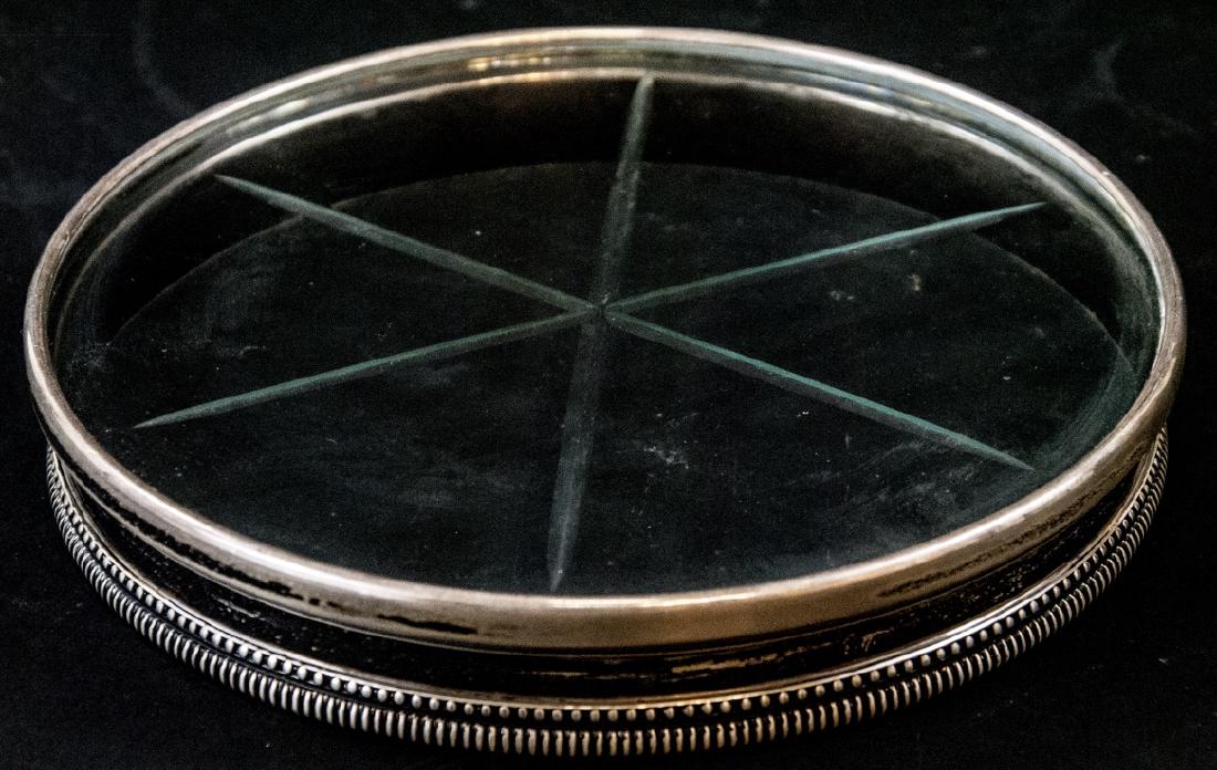 Vintage Sterling Silver Wine Bottle Coaster: Vintage Sterling Silver Wine Bottle Coaster . This cut glass wine bottle coaster features a sterling silver decorative border. 1 inch x 6 inches.