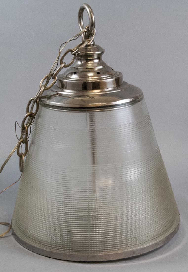 Industrial Style Modern Glass Pendent Light: Industrial Style Modern Glass Pendent Light. Very large pendent light ideal for over kitchen island. Nickel color accents on ribbed glass. Bulbs are covered. 21 inches x 15 inches in diameter