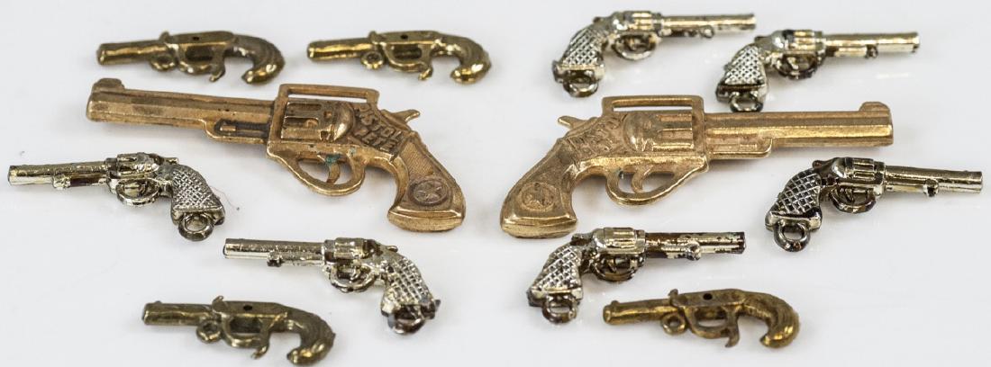 Collection of Gilt Metal Costume Jewelry Guns: Collection of Gilt Metal Costume Jewelry Guns / Pistols for Charms / Pendants. Largest measures 2.5 inches and says Pistol Pete