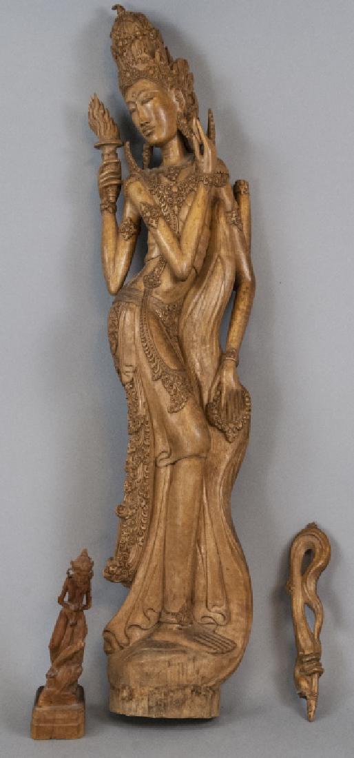 Lot of Mid Century Hand Carved Balinese Figures: Lot of Mid Century Hand Carved Balinese Figures. Lot includes two hand carved Balinese figures of goddesses. Both figures are of mixed style and feature intricate carved details. Hand holding staff of