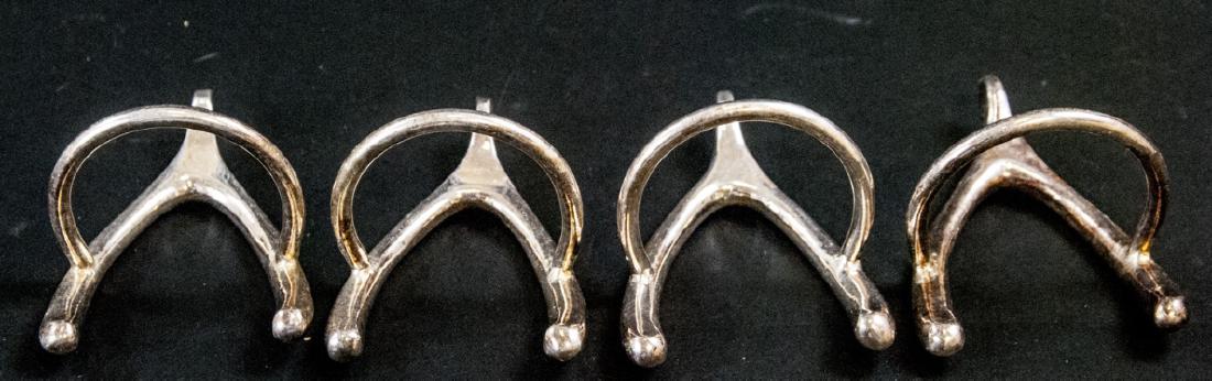Set of Wishbone Motif Silver Plate Napkin Rings: Set of Wishbone Motif Silver Plate Napkin Rings. Each measures 2.75 inches in length.