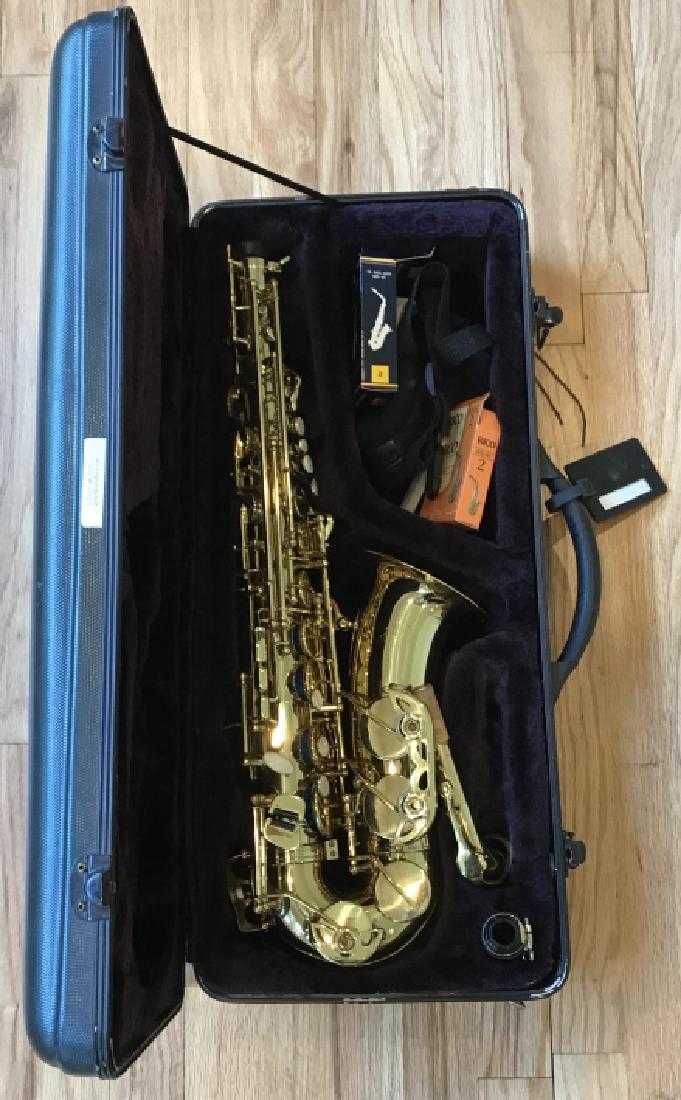 Grand Saxophone & Case: Grand Saxophone & Case. This lot includes a saxophone by Grand and a carrying / storage case. Case measures 5 inches x 24 inches x 10 inches.