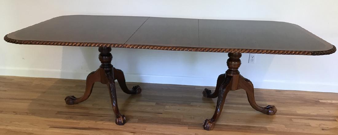 Sheraton Style Mahogany Dining Table W Ball & Claw: Sheraton Style Mahogany Dining Table W Ball & Claw. This mahogany dining table having a Sheraton style features ball and claw feet, turned balusters, and a carved twist detail surrounding the edge of