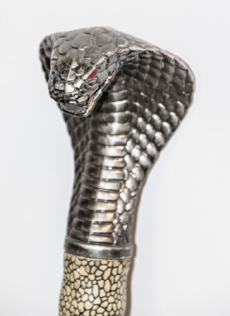 Vtg Stainless Steel Cobra Handle Sword & Sheath: Vtg Stainless Steel Cobra Handle Sword & Sheath. This vintage sword having a stainless steel blade features a cobra handle / finial and sheath. 43 inches, blade measures 28 inches.