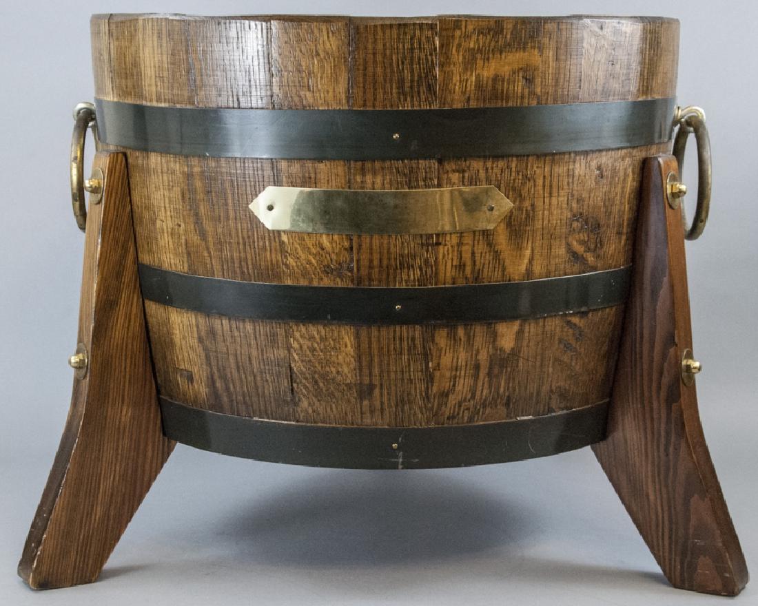 Wood Barrel Cellarette / Wine Bucket Brass Accents: Wood Barrel Cellarette / Wine Bucket Brass Accents Wood Barrel Cellarette / Wine Bucket with Brass handles and accents, and 3 wide curved wooden Legs. Measures 19 x 21 inches.