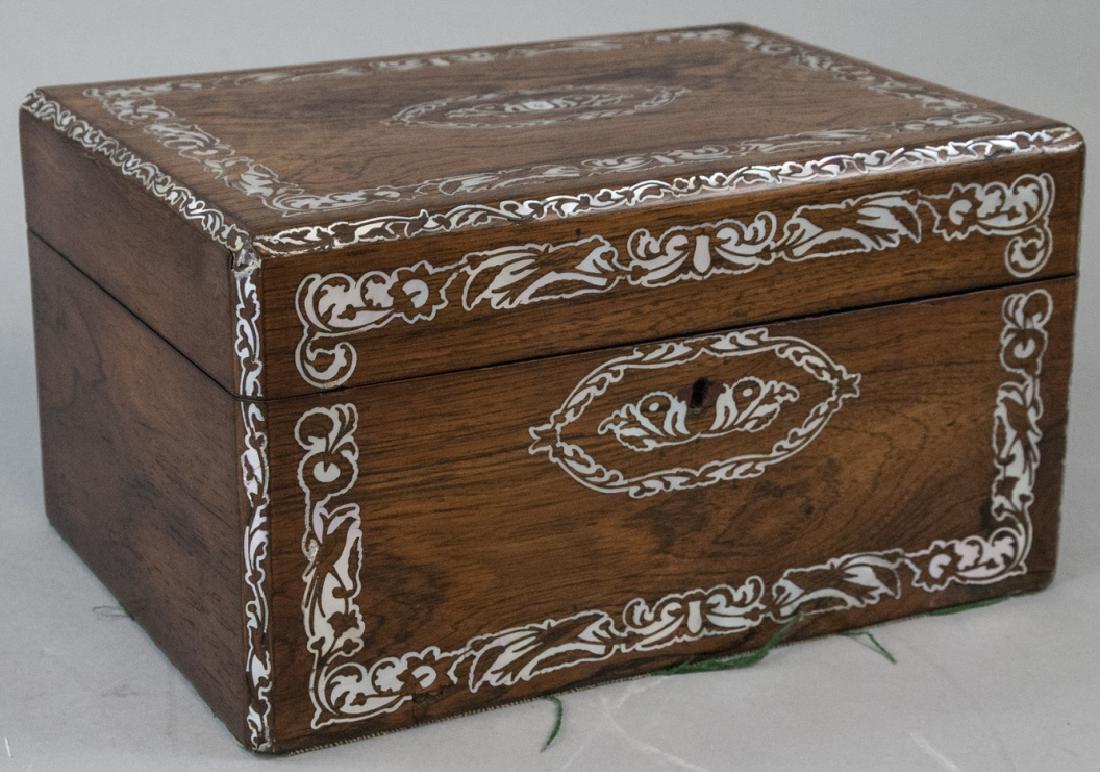 Antique 19th Century English Inlaid Jewelry Box: Antique 19th Century English Inlaid Jewelry Box. This antique 19th century English jewelry box features mother of pearl inlay. The red velvet lined interior is compartmentalized and features one remov