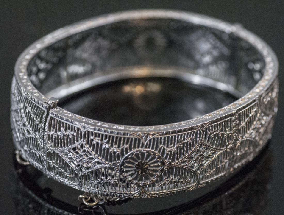 Estate Edwardian Style Filigree Bangle Bracelet: Estate Edwardian Style Filigree Bangle Bracelet. Safety chain. Measures 2.25 inches across the opening.