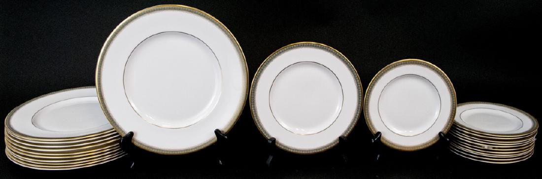 English Royal Doulton Bone China Dinner Service: English Royal Doulton Bone China Dinner Service. Having a sage green and gilt border motif in the pattern "Clarendon". Includes 11 dinner plates, 1 lunch plate, and 12 appetizer plates. Dinner plates 