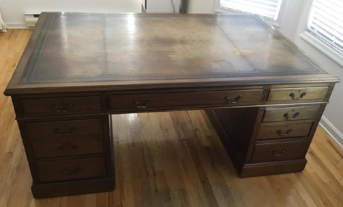Traditional Style Leather Embossed Partners Desk: Traditional Style Leather Embossed Partners Desk. Leather embossed surface, 10 drawers on each side (20 drawers total), brass hardware. 31 inches x 70 inches x 46 inches.