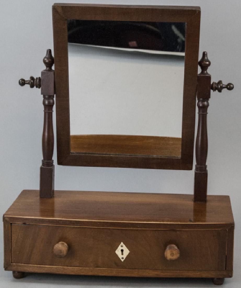 Antique American Federal Style Dressing Mirror: Antique American Federal Style Dressing Mirror. This antique dressing mirror having an American Federal style features an upper mirror with a swivel function over one drawer with bone hardware. Bow fr