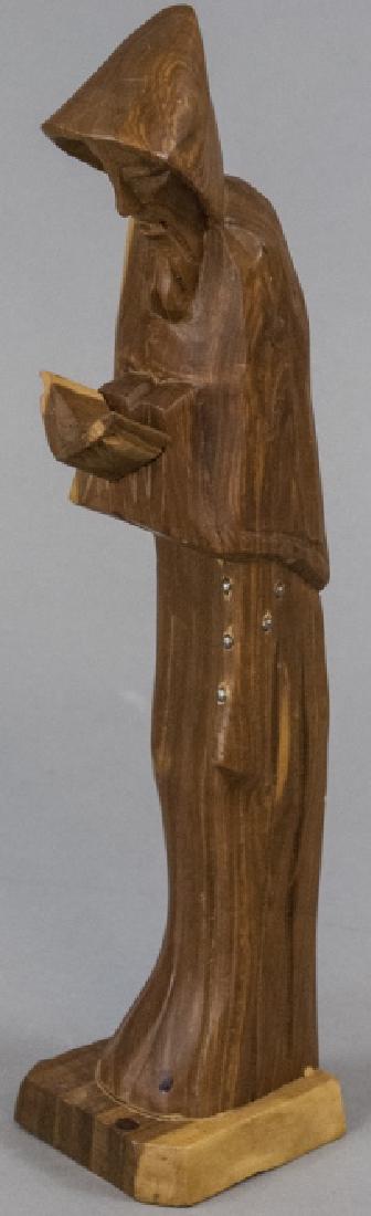 Hand Carved Wooden Mexican Santos Figurine: Hand Carved Wooden Mexican Santos Figurine. This hand carved Mexican wooden figural sculpture features a cloaked santos / saint figure reading a prayer book. 11.5 inches x 2.5 inches x 2.5 inches.