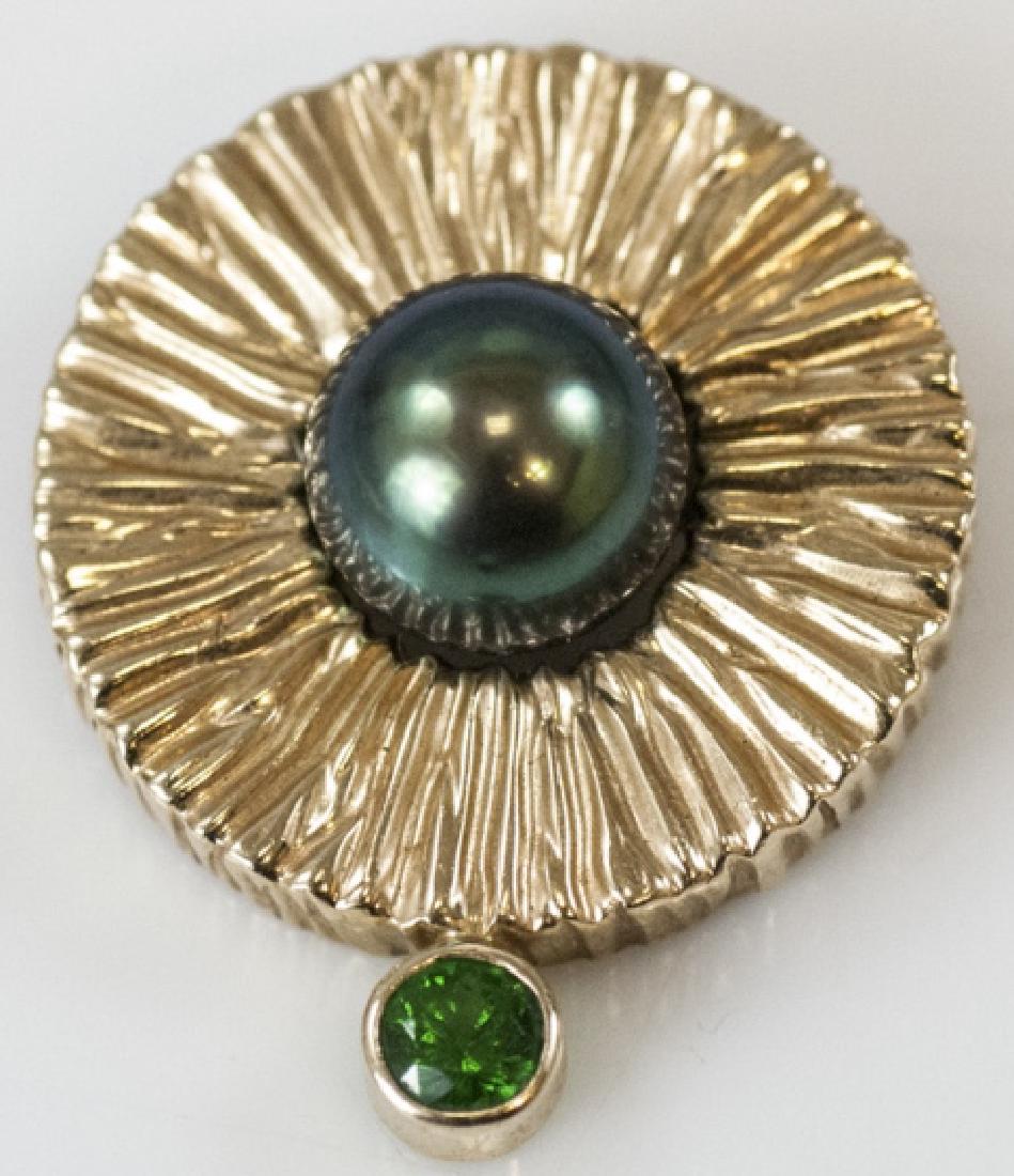 Estate 14kt Yellow Gold & Tahitian Pearl Pendant: Estate 14kt Yellow Gold & Tahitian Pearl Pendant. Textured 14kt yellow gold surround set with one high luster silver / black tone Tahitian cultured pearl at center with peridot drop. Measures 1 inch i