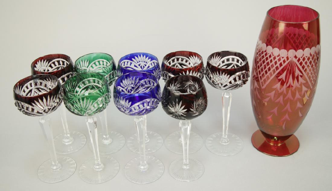 9 Bohemian Glass Wine Glasses & Vase: 9 Bohemian Glass Wine Glasses & Vase. This lot includes nine mixed pattern Bohemian crystal wine glasses and one Bohemian glass vase. Vase measures 11.5 inches x 4 inches in diameter.