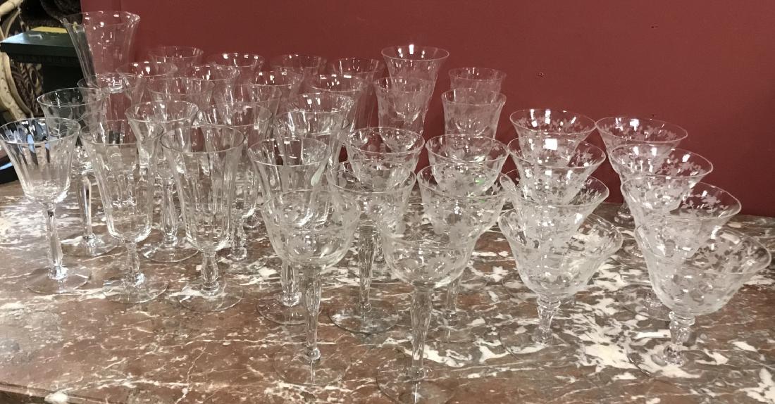 Lot of Vintage Crystal Stemware: Lot of Vintage Crystal Stemware. This lot includes pieces of crystal stemware in three different patterns, and includes wine glasses, goblets, and flutes. Largest piece measures 6 inches x 3 inches in