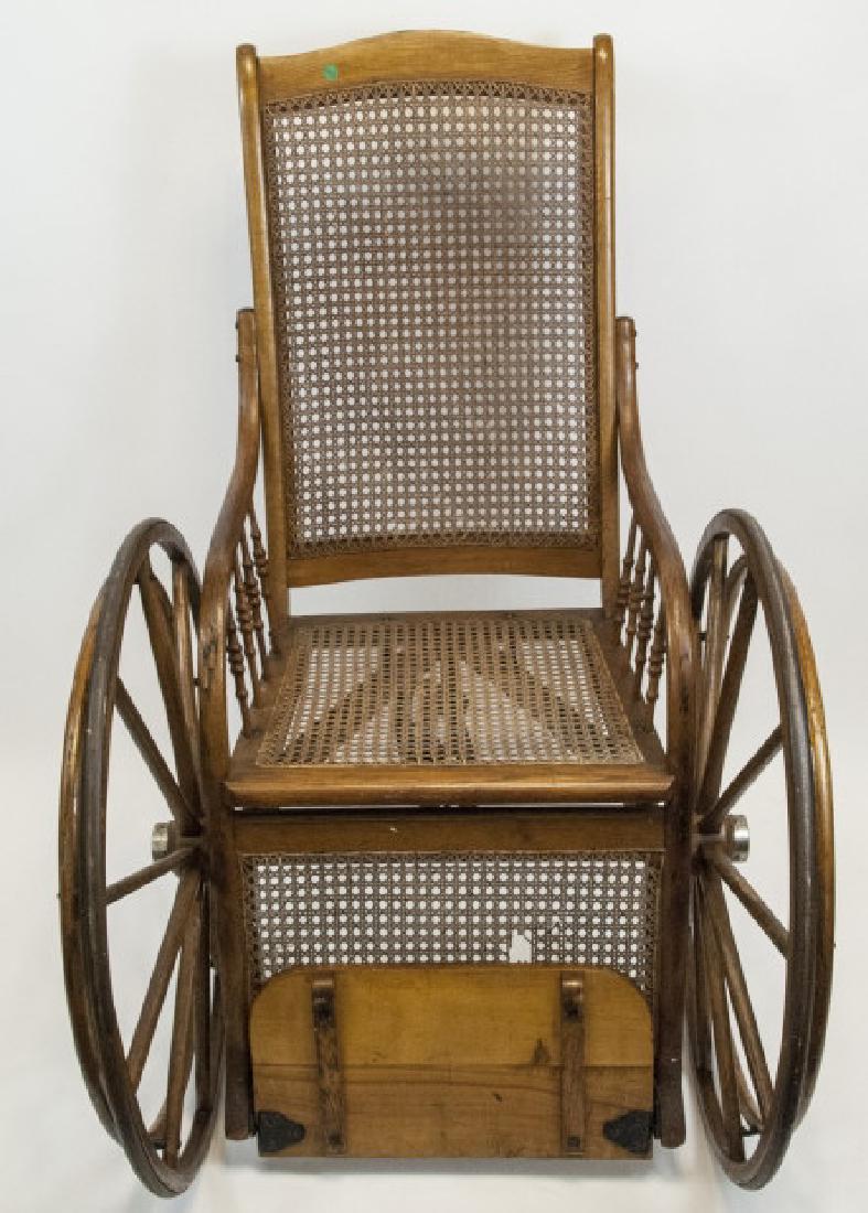 Antique Wood and Cane Wheelchair: Antique Wood and Cane Wheelchair. Made by the New Haven Folding Chair Co. 48 inches x 29 inches x 27 inches
