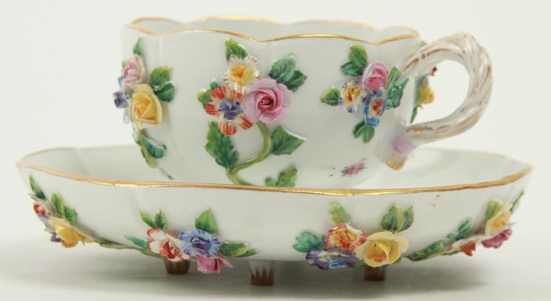 Antique Meissen Porcelain Floral Demitasse Cup: Antique Meissen Porcelain Floral Demitasse Cup & Saucer. Having all over floral encrusted porcelain and gilt details. Each piece bears the Meissen crossed sword mark. Cup measures 2 inches x 4 inches