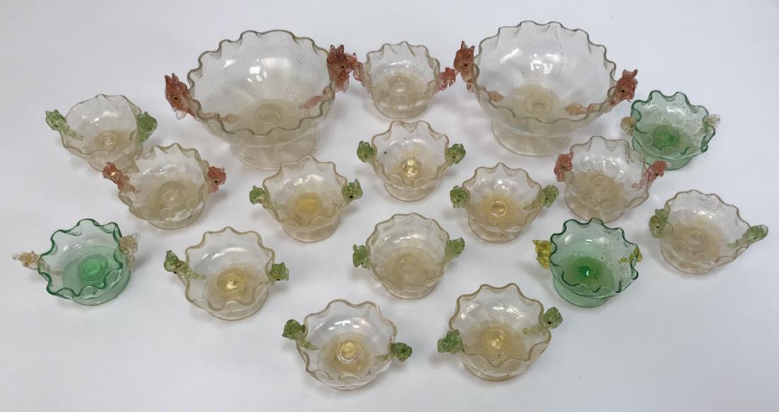 17 Piece Art Glass Caviar / Compote Service: 17 Piece Art Glass Caviar / Compote Service. This lot features two large art glass compotes and 15 small caviar dishes / compotes featuring figural sturgeon handles. Largest measures 3 inches x 5 inch