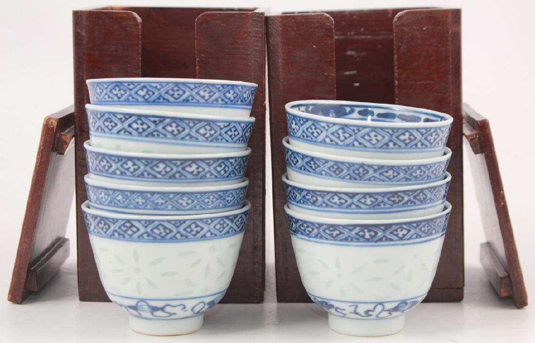 9 Antique Chinese Blue & White Porcelain Wine Cups: 9 Antique Chinese Blue & White Porcelain Wine Cups. Each are signed and feature a rice patterned motif. Includes two wooden storage boxes. Each cup measures approximately 2.25 inches x 3 inches in dia