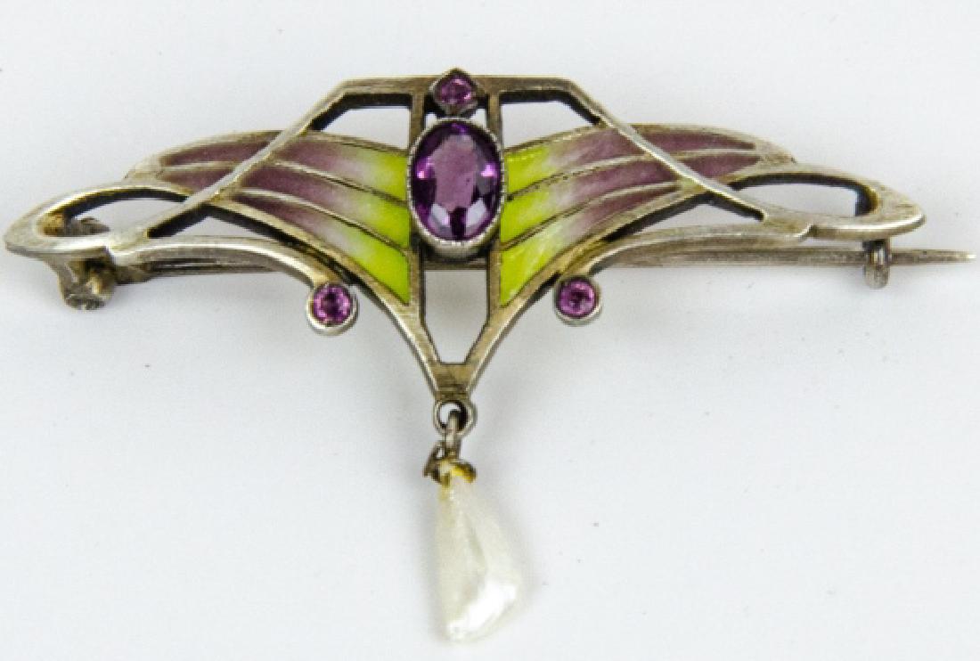 Antique Art Nouveau Plique a Jour Enamel Brooch: Antique Art Nouveau Plique a Jour Enamel Brooch. Antique Art Nouveau, silver frame, plique a jour enamel, amethyst and baroque seed pearl. Measures 1.75 inches in width.