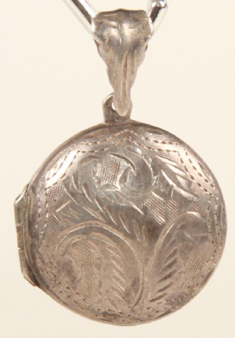 Sterling Silver Chased Scrollwork Motif Locket: Sterling Silver Chased Scrollwork Motif Locket Necklace Pendant. Measures just under 1.5 inches in length.