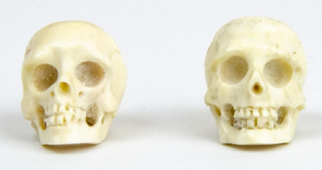 Pair of Hand Carved Bone Memento Mori Skulls: Pair of Hand Carved Bone Memento Mori Skulls for Jewelry Making. Each well detailed and measuring approximately 1 inch in length.