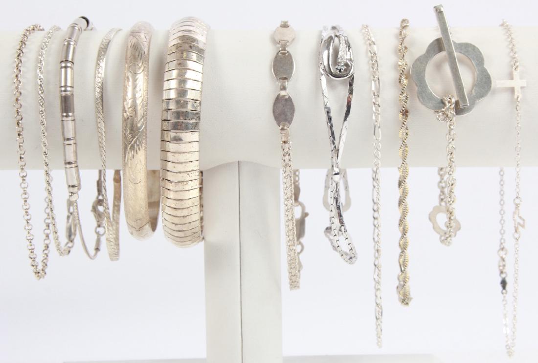 Dozen Sterling Silver Chain Link Bracelets: Dozen Sterling Silver Chain Link Bracelets. Various makers and styles. All bracelets measure approximately 7 inches in length.