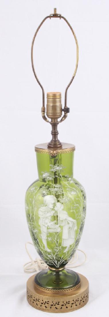 Etched Art Glass Pitcher Form Table Lamp: Etched Art Glass Pitcher Form Table Lamp. Glass features a vignette of a boy and girl kissing. 26 inches x 6 inches in diameter with harp.