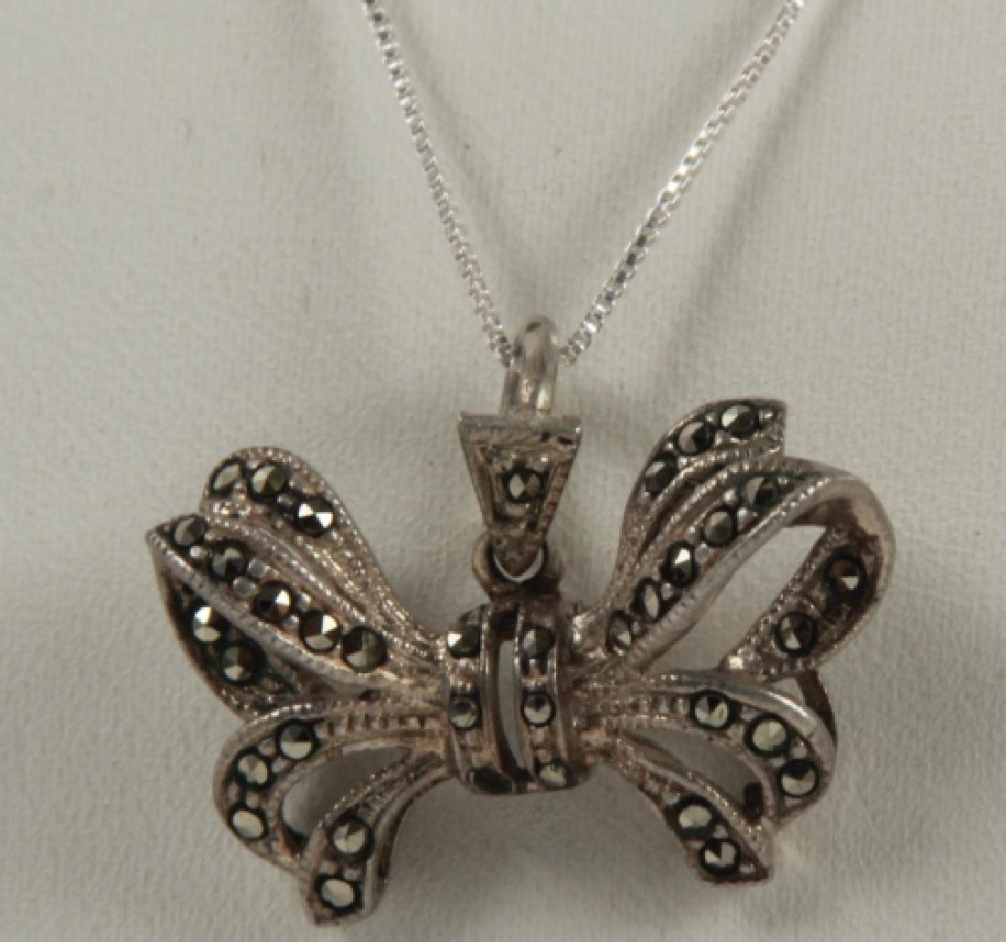 Vintage Sterling Silver & Marcasite Bow Necklace: Vintage Sterling Silver & Marcasite Bow Necklace. Sterling silver chain measures 16 inches in length.