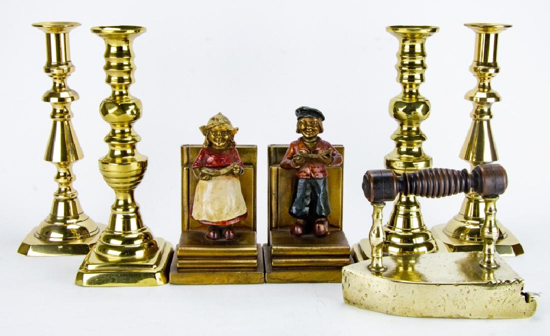 Lot of Vintage Brass Decorative Objects: Lot of Vintage Brass Decorative Objects. Includes two pairs of candle sticks, one iron with cast iron insert, and a pair of bookends by Armor Bronze Co. Largest item measures 10 inches x 4.5 inches x