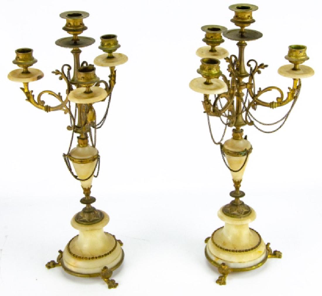 2 French Empire Style Alabaster & Brass Candelabra: 2 French Empire Style Alabaster & Brass Candelabras. This pair of French Empire style candelabras each allow for four candles and feature alabaster and brass details. Each measures approximately 18.5 