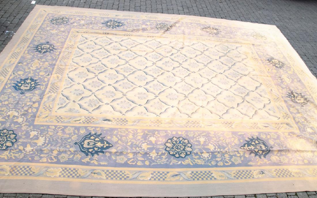 Safavieh French Auboisson Tapestry Woven Carpet: Safavieh French Aubusson Tapestry Woven Carpet. In the style of a French Aubusson. Muted blue and beige tones with repeating scalloped and floral style patterns. Carpet has color loss from the sun. 14