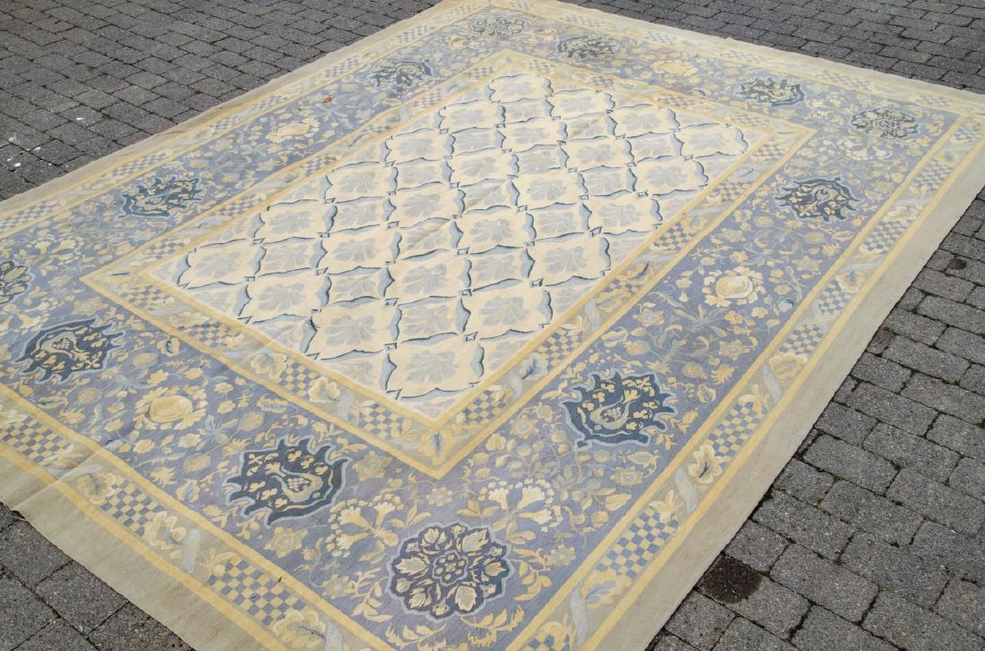 Safavieh Aubusson Tapestry Woven Carpet: Safavieh Aubusson Tapestry Woven Carpet. In the style of a French Aubusson. Muted blue and beige tones with repeating scalloped and floral style patterns. 8 feet by 10 feet.