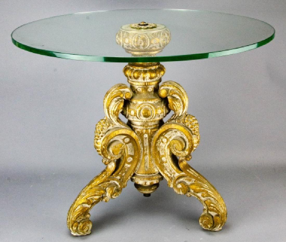 Florentine Style Glass Top Coffee Table: Florentine Style Glass Top Coffee Table. Having a carved wood base with a round glass top. 19 inches x 24 inches.