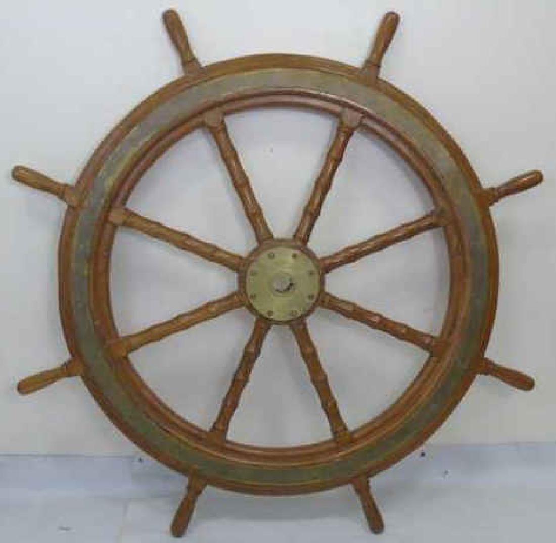 Very Large Carved Wood & Brass Ships Wheel: Very Large Carved Wood & Brass Ships Steering Wheel. Carved wood and brass frame. Measures 57 inches in diameter.