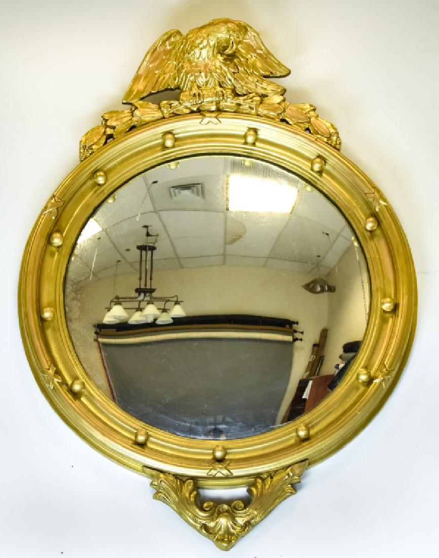 American Federal Style Convex Gilt Mirror: American Federal Style Convex Gilt Mirror. Features a figural eagle pediment and gilt frame surrounding the center convex mirror. 30 inches x 22 inches x 1.5 inches.