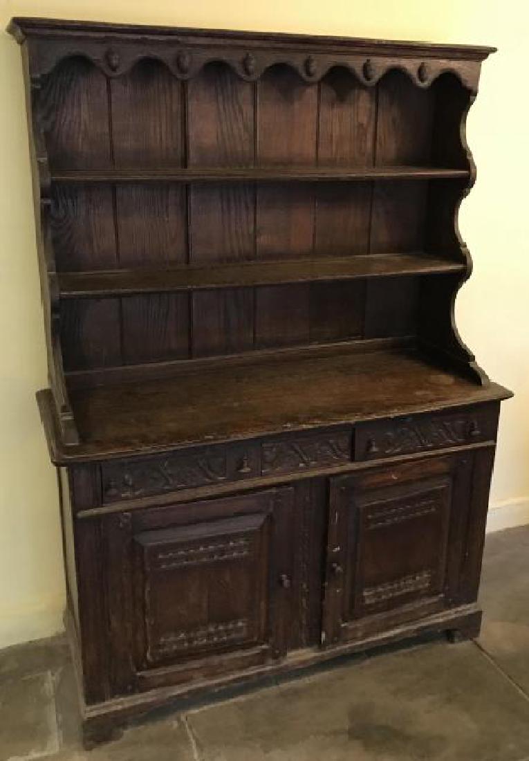 Antique English Tudor / Jacobean Style Hutch: Antique English Tudor / Jacobean Style Hutch. Step back hutch cupboard with open shelf top and storage base. Needs repair to leg / restoration. Measures 68 x 49 x 18 inches.