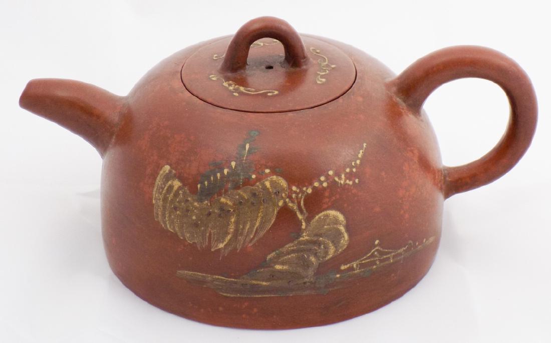 Chinese Zisha Purple Sand Teapot Gu Jing Zhou: Chinese Zisha Purple Sand Teapot Gu Jing Zhou. Having hand painted floral surface decoration, marked Master Gu Jing Zhou. 3 inches x 7 inches x 5 inches.