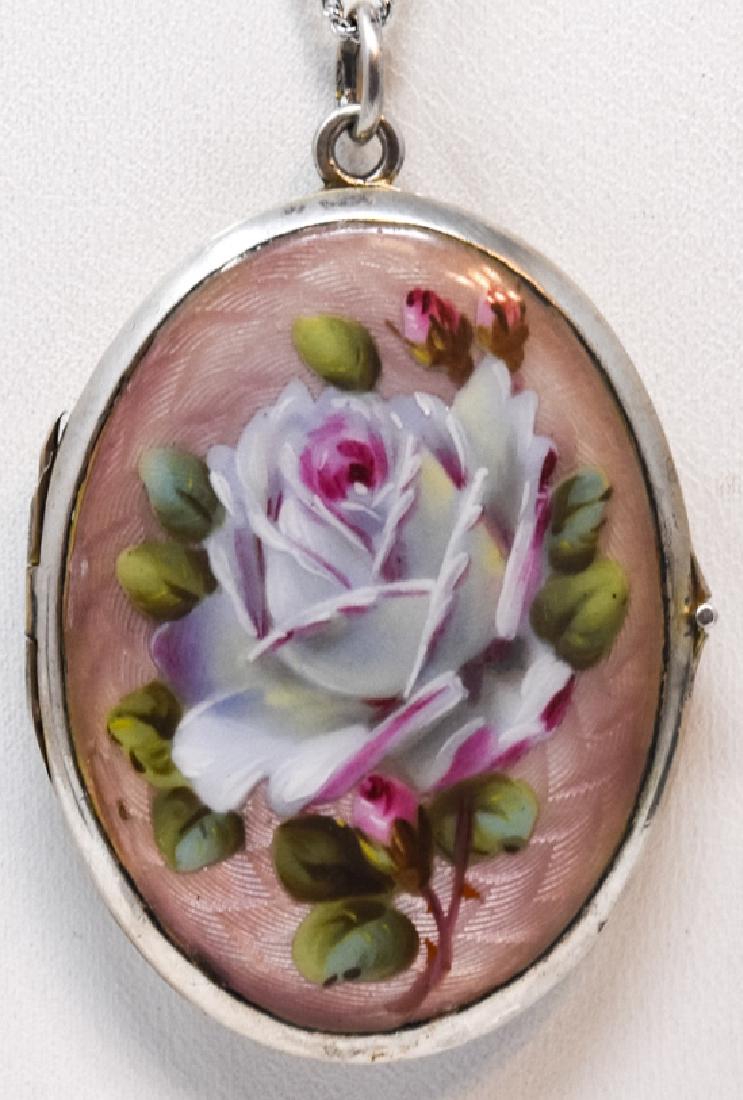 Antique Art Nouveau Silver & Enamel Locket: Antique Art Nouveau Silver & Enamel Locket. 800 silver and enamel locket with rose motif. Chain measures 17.5 inches, locket measures 2.25 inches in length.