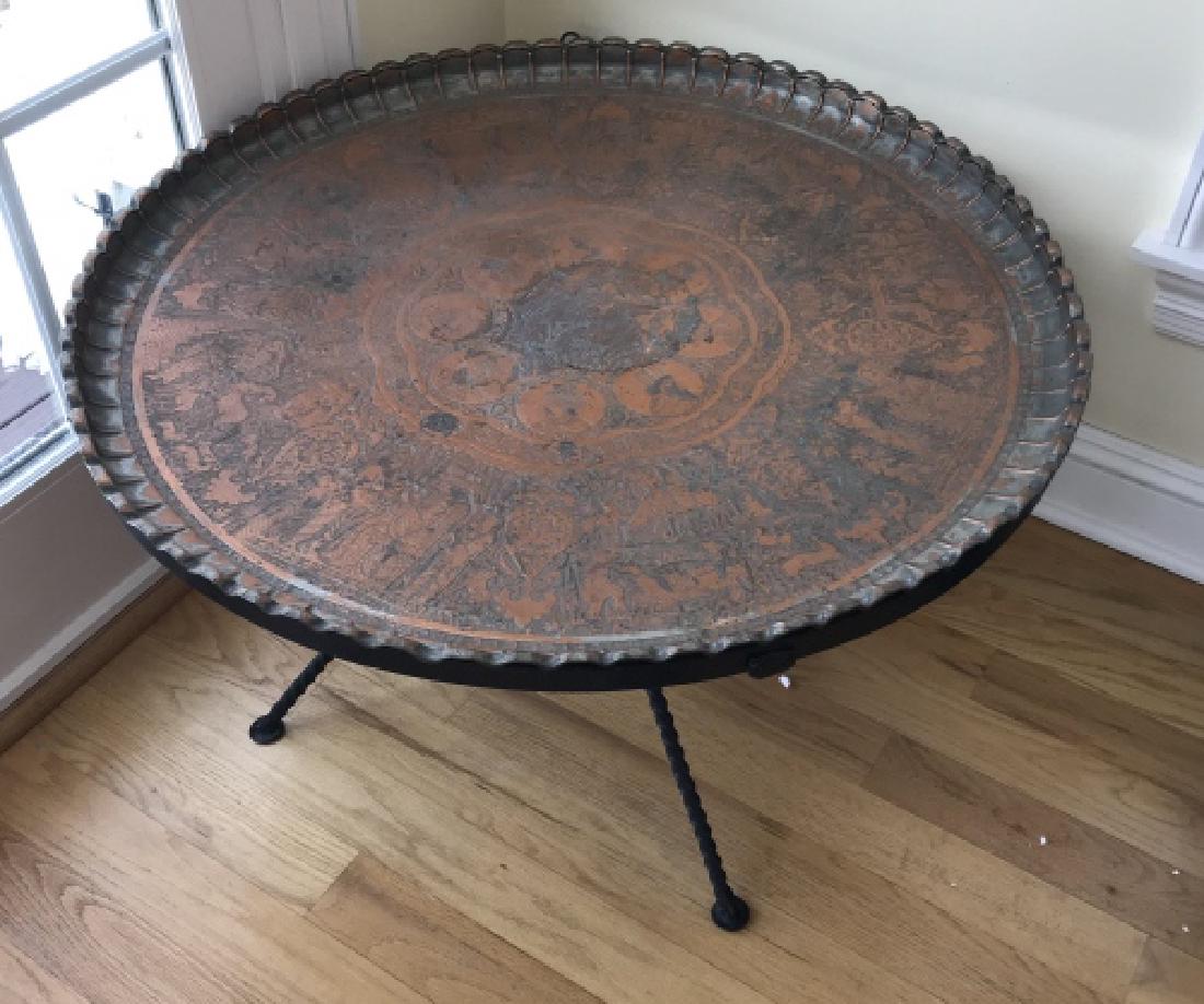 Vintage Persian Style Chased Tray Top Coffee Table: Vintage Persian Style Chased Tray Top Coffee Table. Wrought iron base. Measures 19 x 33.5 inches. Property of a Ridgefield, Connecticut estate.