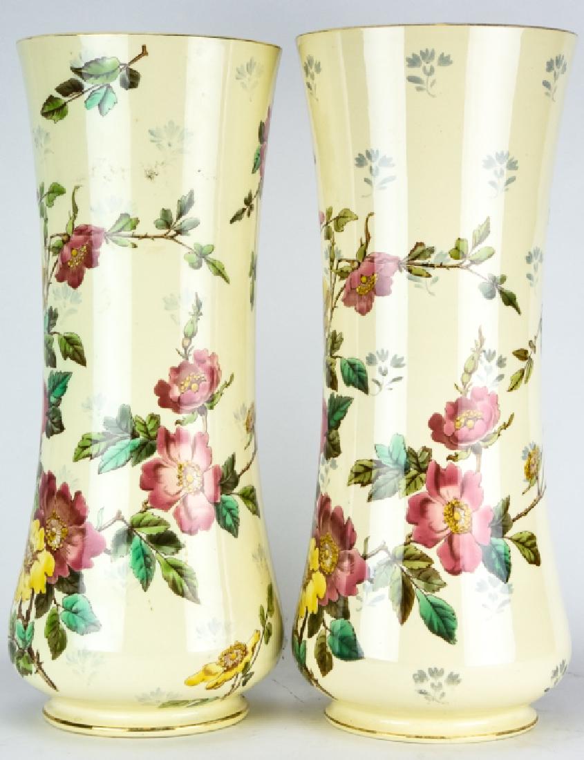 Pair Floral Motif Transfer Ware Porcelain Vases: Pair Floral Motif Transfer Ware Porcelain Vases. Each features a transfer ware floral motif with hand painted embellishments. 17.5 inches x 7 inches in diameter.