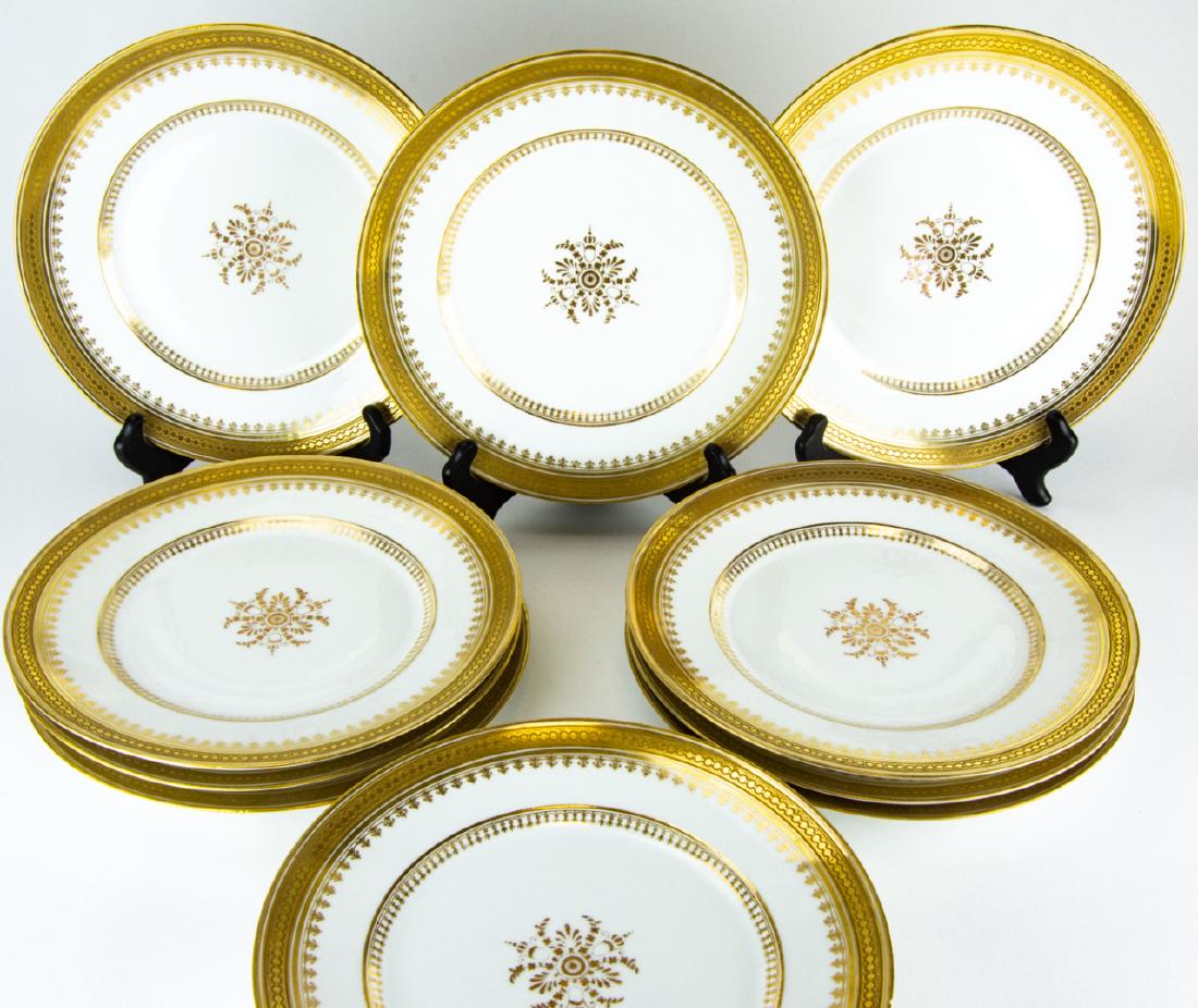 12 D & C Limoges France Gilt Porcelain Plates: 12 D & C Limoges France Gilt Porcelain Plates. This lot includes 12 porcelain plates with a gilt patterned and central medallion motif marked D & C France L. Bernardaud & Co Limoges. 9.5 inches in dia