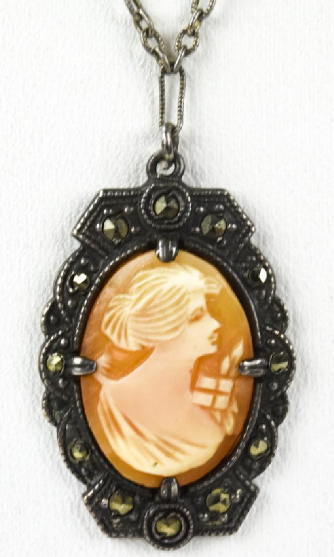 Sterling Hand Carved Natural Shell Malachite Cameo: Vintage Sterling Hand Carved Natural Shell Malachite Cameo on Delicate Book Chain. Cameo is surrounded by inlaid Malachite. Chain is 18 inches, cameo is 1.25 inches.