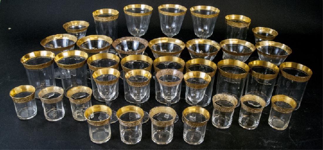 Antique Gold Rim Stemware, 34 glasses: 10 aperitif glasses, 7 cordial glasses, 4 stemmed after dinner glasses, 3 large wine glasses, 2 large stem less water glasses, 8 medium stem less water glasses. Minor ware to gold trim and chipping. L