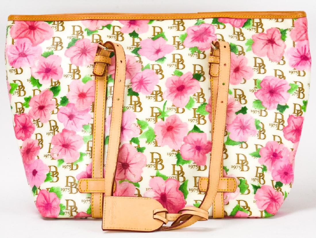 Dooney & Bourke Hibiscus Leather Tote Bag / Purse: Dooney & Bourke Hibiscus Leather Tote Bag / Purse. Shopper tote bag with hibiscus and monogrammed motif from Dooney and Bourke. Leather trim and handles. 11.5 inches x 16.5 inches without straps. Prop