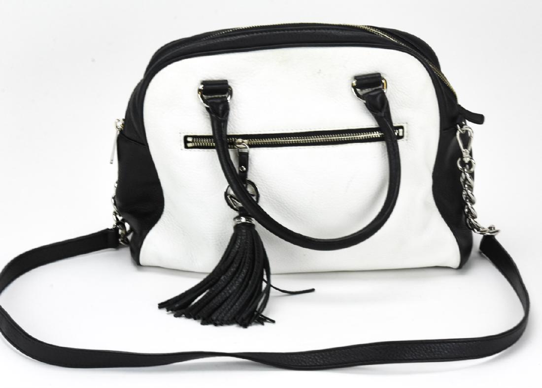 Michael Kors Leather Handbag / Purse: Michael Kors Leather Handbag / Purse. Black and white leather handbag by Michael Kors. Measures approximately 10 inches x 12 inches x 4 inches without straps. Property of an Irvington, New York estate