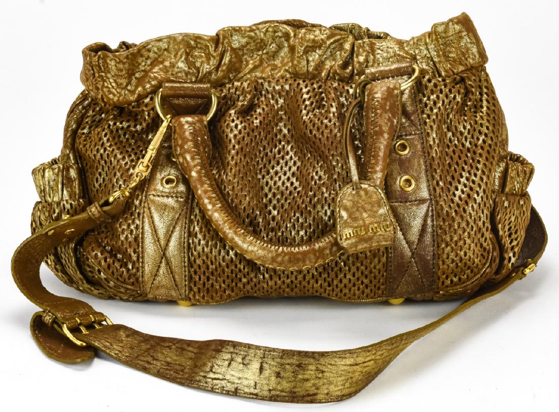 Miu Miu Gold Leather Handbag / Purse: Miu Miu Gold Leather Handbag / Purse. Gold toned perforated leather handbag by Miu Miu. Interior is also leather lined with gold toned hardware. Measures approximately 8 inches x 12 inches x 4.5 inche