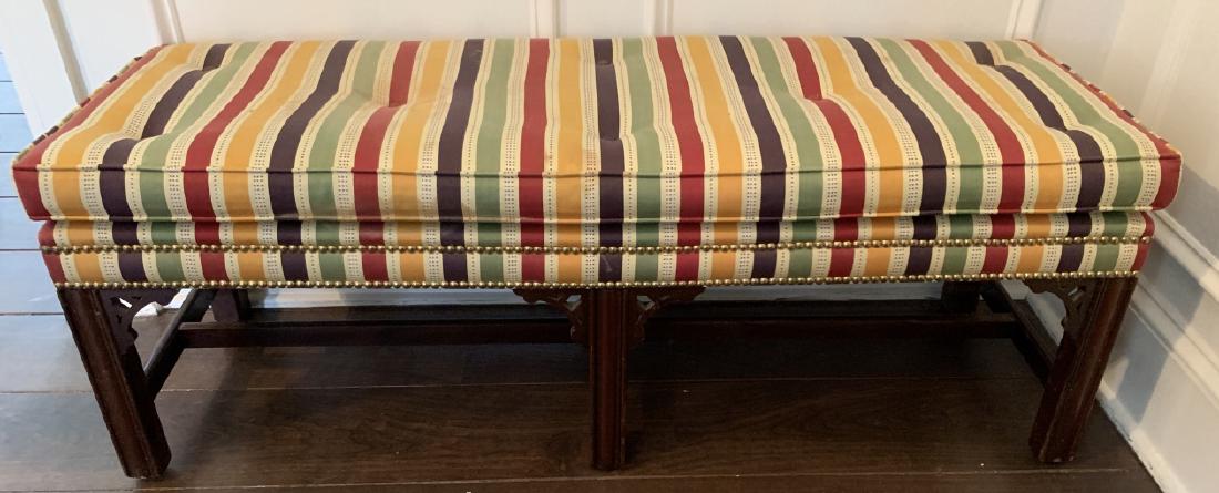 Custom Upholstered Bench W Asian Style Wood Frame: Custom Upholstered Bench W Asian Style Wood Frame. This lot features a custom upholstered bench in striped fabric with an Asian style wooden frame and brass nail head trim. 17 inches x 48 inches x 16 