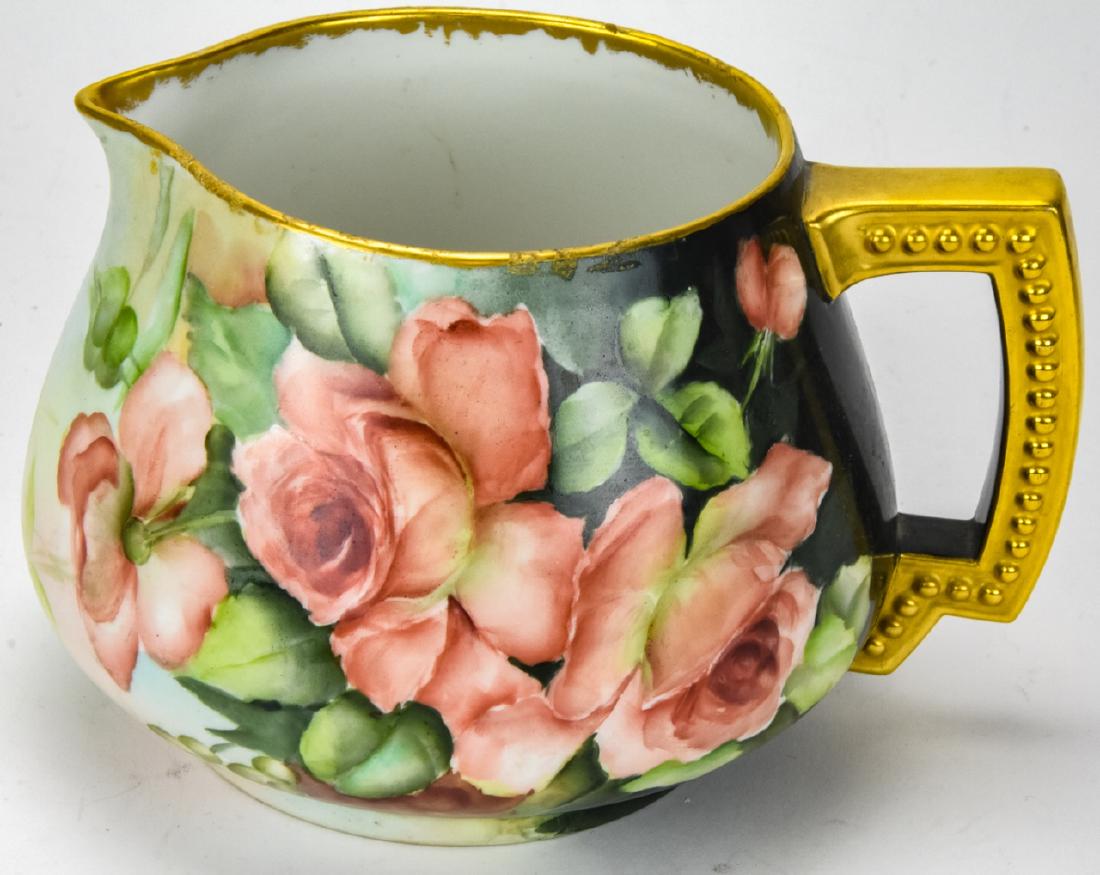 Antique Jean Pouyet Limoges Porcelain Cider Jug: Antique Jean Pouyet Limoges Porcelain Cider Jug / Pitcher. Features a hand painted floral motif with gilt handle and rim. Marked on bottom. Measures 6.5 inches x 8 inches x 7 inches. Property of an Ir